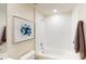 Bright bathroom featuring white tile, a shower/tub combo, and modern fixtures at 4747 Golden Knight Blvd, Kissimmee, FL 34746