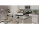 Modern kitchen featuring stainless steel appliances, white cabinets, and a spacious center island with seating at 4747 Golden Knight Blvd, Kissimmee, FL 34746