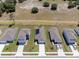 Aerial view of several homes with manicured lawns in a neighborhood with street access and adjacent open land at 726 Eagle Landing Blvd, Winter Haven, FL 33880