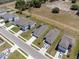 Aerial view showcases houses in a neighborhood featuring well-maintained streets, green spaces, and nearby wooded areas at 726 Eagle Landing Blvd, Winter Haven, FL 33880