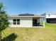 Back of house with patio area and solar panels on roof at 726 Eagle Landing Blvd, Winter Haven, FL 33880