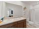 Bright bathroom featuring double sinks, stylish vanity, a toilet, and a shower with a curtained door at 726 Eagle Landing Blvd, Winter Haven, FL 33880