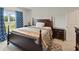 Comfortable bedroom featuring a dark wood four poster bed and light-filled window at 726 Eagle Landing Blvd, Winter Haven, FL 33880