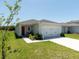 Charming single-story home featuring a manicured lawn, attached two-car garage, and a welcoming front door at 726 Eagle Landing Blvd, Winter Haven, FL 33880