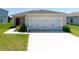 Attached two car garage with front yard at 726 Eagle Landing Blvd, Winter Haven, FL 33880