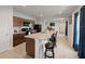 Modern kitchen with a breakfast bar, dark cabinetry, and open view to dining area at 726 Eagle Landing Blvd, Winter Haven, FL 33880