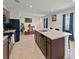 Bright kitchen features a large island with sink, modern appliances and tiled floors at 726 Eagle Landing Blvd, Winter Haven, FL 33880