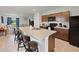 Kitchen features modern appliances, a large island with barstool seating and an open floor plan at 726 Eagle Landing Blvd, Winter Haven, FL 33880