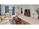Bright living room with comfortable seating, large window view, and decorative accents at 726 Eagle Landing Blvd, Winter Haven, FL 33880