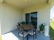 Covered patio with outdoor dining area is perfect for entertaining guests at 726 Eagle Landing Blvd, Winter Haven, FL 33880