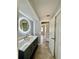 Bathroom with a large vanity, backlit mirror, and tiled flooring at 3465 Peacock Ln, Mulberry, FL 33860