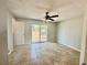 Bedroom featuring tile floors, a ceiling fan, and a sliding glass door leading to the backyard at 3465 Peacock Ln, Mulberry, FL 33860