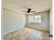 Bright bedroom with tiled flooring, neutral walls, and large window at 3465 Peacock Ln, Mulberry, FL 33860