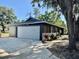 Exterior view of house showing grey garage door, driveway, and modern architectural details at 3465 Peacock Ln, Mulberry, FL 33860