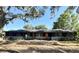 Charming single-story home featuring an inviting front yard with mature trees and a well-maintained exterior at 3465 Peacock Ln, Mulberry, FL 33860