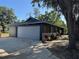 A well-kept home with an attached garage, appealing dark siding, and attractive landscaping at 3465 Peacock Ln, Mulberry, FL 33860