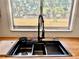Stainless kitchen sink featuring a modern faucet, butcher block countertops, and a bright window view at 3465 Peacock Ln, Mulberry, FL 33860