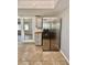 Kitchen featuring stainless steel refrigerator, tiled flooring, and gray cabinetry at 3465 Peacock Ln, Mulberry, FL 33860