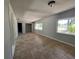 The light and airy living room with neutral walls and floors is bathed in natural light at 3465 Peacock Ln, Mulberry, FL 33860