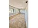 Open living room with neutral walls and tile flooring, showcasing the home's layout at 3465 Peacock Ln, Mulberry, FL 33860