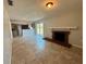The comfortable living room features a brick fireplace, ceramic tile flooring, and access to the back yard at 3465 Peacock Ln, Mulberry, FL 33860