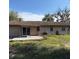 Home back exterior featuring a wood deck, sliding glass door, and expansive backyard at 3640 Chart Prine Rd, Lakeland, FL 33810