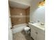 Cozy bathroom featuring a bathtub with tiled walls, a toilet, and a vanity with sink, with decorative lighting above at 3640 Chart Prine Rd, Lakeland, FL 33810