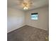 Cozy bedroom featuring carpet, a ceiling fan with lighting, and a window overlooking the exterior at 3640 Chart Prine Rd, Lakeland, FL 33810
