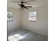 Bright bedroom with neutral carpet, ceiling fan with lighting, and two windows offering natural light at 3640 Chart Prine Rd, Lakeland, FL 33810