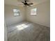 Comfortable bedroom featuring carpet, a ceiling fan, and dual windows for ample natural light at 3640 Chart Prine Rd, Lakeland, FL 33810