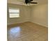 Bright and spacious living room featuring tile floors and a ceiling fan, providing a comfortable living space at 3640 Chart Prine Rd, Lakeland, FL 33810