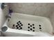 The bathtub features tile walls and black hexagon grips at 4707 Melody Ln, Lakeland, FL 33805