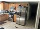 Galley kitchen featuring stainless steel appliances and light wood cabinetry at 4707 Melody Ln, Lakeland, FL 33805
