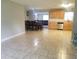 Open-concept kitchen and dining area featuring wood cabinets and tile flooring at 4707 Melody Ln, Lakeland, FL 33805