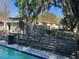 Inviting pool area enclosed by a rustic wooden fence, offering privacy and a charming backyard view at 4707 Melody Ln, Lakeland, FL 33805