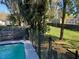 Scenic view of a pool with a modern fence and lush greenery, creating a serene outdoor space at 4707 Melody Ln, Lakeland, FL 33805