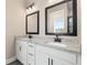 Bathroom featuring double sinks, granite countertops, and modern black fixtures at 7733 Somersworth Dr, Kissimmee, FL 34747