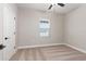 Cozy bedroom with plush carpet, a window for natural light, and a neutral color scheme at 7733 Somersworth Dr, Kissimmee, FL 34747
