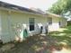 The exterior of this single-story residence features a well-kept lawn, windows, and AC unit at 1184 Athlone Way, Ormond Beach, FL 32174