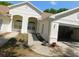Inviting single-story home featuring arched windows, attached garage, and tidy landscaping at 1184 Athlone Way, Ormond Beach, FL 32174