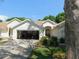 Charming single-story home with attached garage and lush landscaping, creating inviting curb appeal at 1184 Athlone Way, Ormond Beach, FL 32174