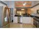 Bright kitchen with stainless steel appliances, tile floors, and a pass-through to the living area at 1184 Athlone Way, Ormond Beach, FL 32174