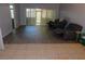 Living room featuring hard surface flooring and sliding glass doors leading to a screened patio at 1184 Athlone Way, Ormond Beach, FL 32174