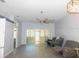 Spacious living room with a ceiling fan and sliding glass doors leading to a screened patio at 1184 Athlone Way, Ormond Beach, FL 32174