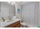 Bright bathroom with vanity, shower/tub combination and commode at 1401 Wexford Way, Davenport, FL 33896