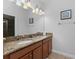 Bathroom featuring double sink vanity with granite countertop and modern lighting at 1401 Wexford Way, Davenport, FL 33896