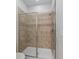 Tiled walk-in shower with glass door and modern fixtures at 1401 Wexford Way, Davenport, FL 33896