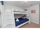 This bedroom features a white bunk bed with built-in stairs and American flag themed decor at 1401 Wexford Way, Davenport, FL 33896