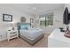 Tastefully decorated bedroom with a gray upholstered headboard, framed art, and a ceiling fan at 1401 Wexford Way, Davenport, FL 33896
