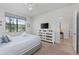 Cozy bedroom featuring a mirrored dresser and a window with patterned blinds at 1401 Wexford Way, Davenport, FL 33896